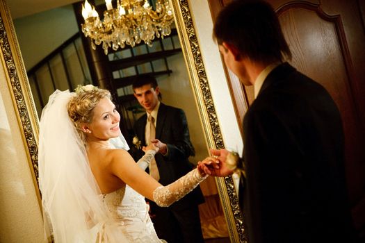 bride and groom by the mirror