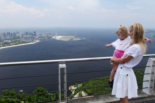 small girl with mother at a high viewing platform