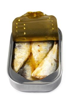 Open can of sardines, casting soft shadow on white.