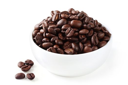 Coffee beans in a small white bowl, on white.