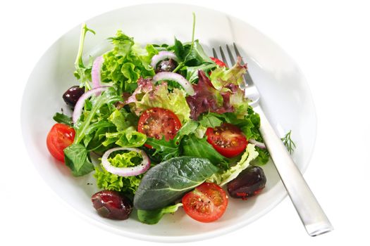 Simple garden salad in a white bowl with fork.