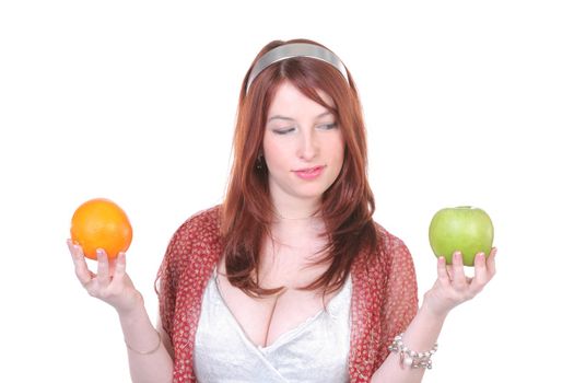 beautiful girl chooses between orange and apple