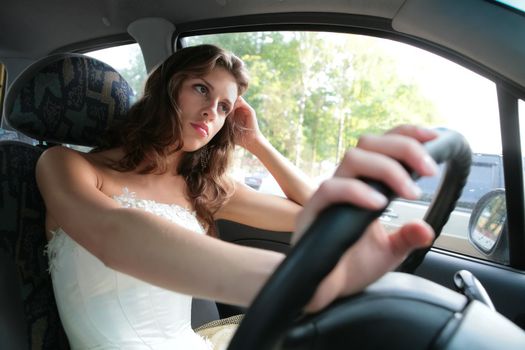 pensive beautiful girl driver controls car