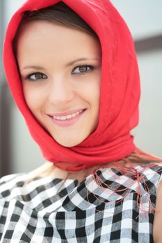 smiling pretty girl in red kerchief, closeup portrait