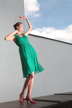 dancing girl in green dress and red loafer