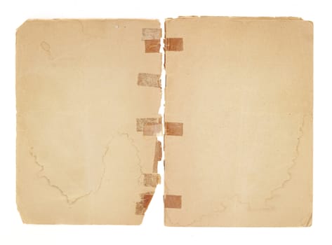 Two blank facing pages from an old pamphlet.  There is very old, yellowed tape on broken binding. The paper is water stained, torn and yellowing with rough edges and dogeared corners.