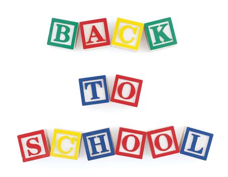 Wooden alphabet blocks on  white arranged to form the words, 'back to school'