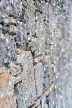 Detail of a luxurious swimming pool wall with waterfalls