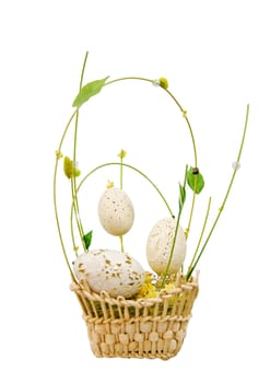 Wicker basket with decorative easter eggs isolated over white