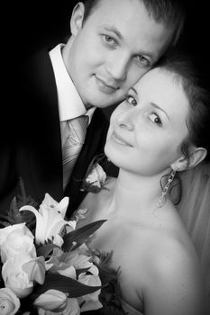 Bride and groom portrait on black background