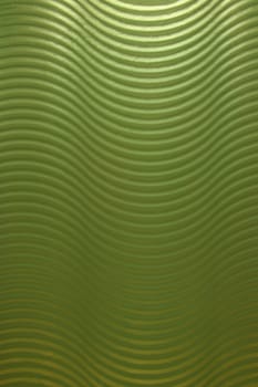 A green wavy abstract glass wall that makes a wonderful texture