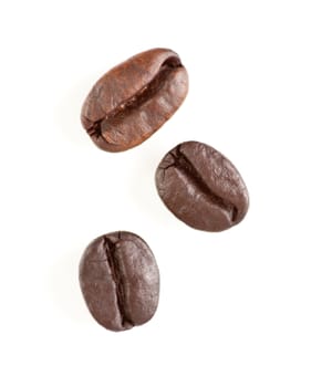 Three Roasted Coffee Beans Isolated on White with Narrow Depth of Field.