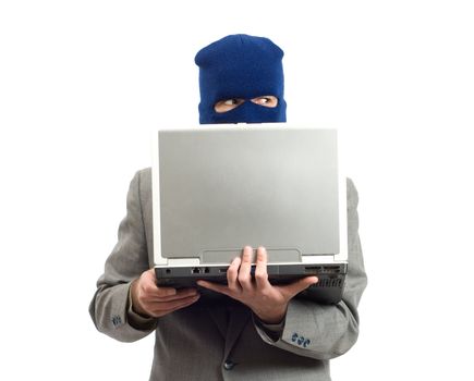 A businessman wearing a mask using a laptop computer to change his identity