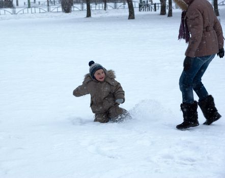 woman with the son play a snow field