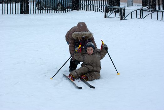 The boy has fallen during skiing