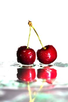 two cherries on watered glass