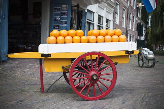 Cart in front of a market full of cheese