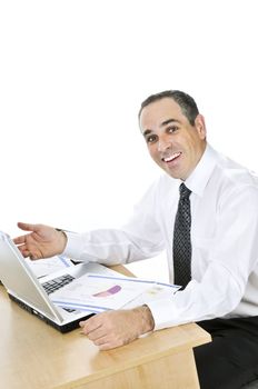 Happy smiling businessman sitting at his desk isolated on white background
