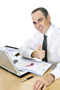 Happy smiling businessman sitting at his desk isolated on white background