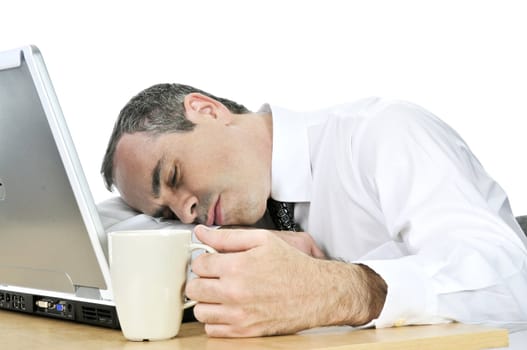 Tired businessman asleep at his desk isolated on white background