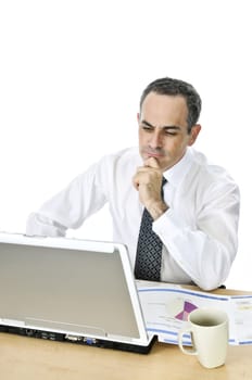 Thoughtful businessman sitting at his desk isolated on white background