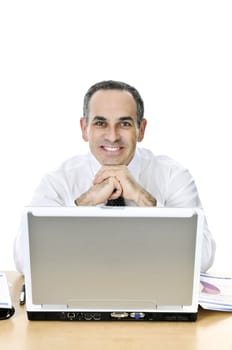 Happy businessman sitting at his desk isolated on white background