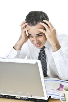 Stressed businessman sitting at his desk isolated on white background