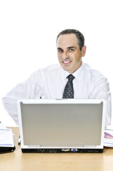 Happy businessman sitting at his desk isolated on white background