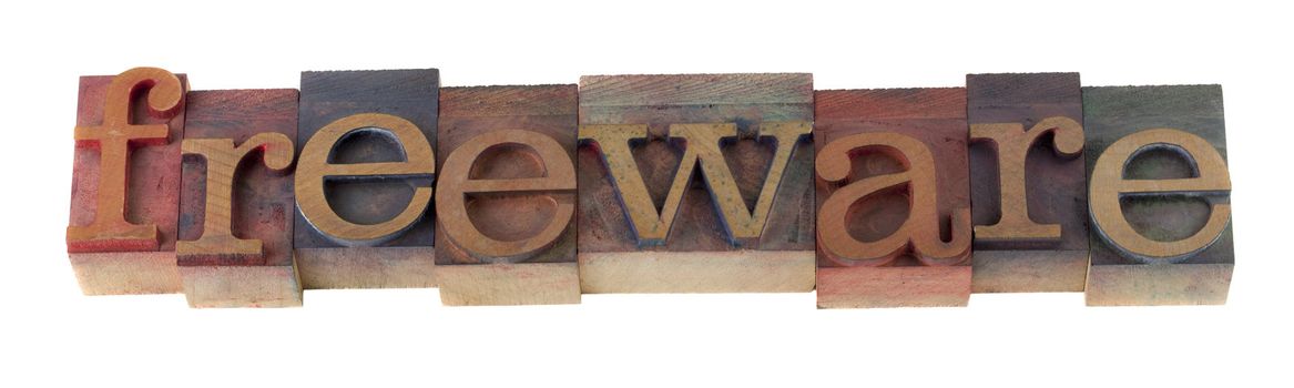 freeware word  in vintage wooden letterpress type blocks, stained by color ink, isolated on white