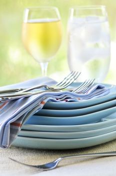 Table setting with stack of plates and cutlery