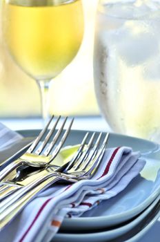 Table setting with stack of plates and cutlery