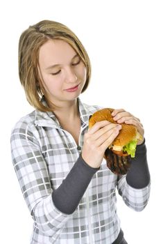 Teenage girl holding a big hamburger isolated on white background