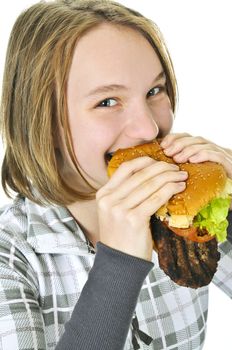 Teenage girl holding a big hamburger isolated on white background