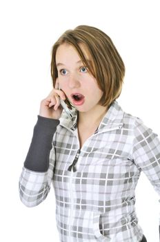 Teenage girl talking on a cell phone acting surprised isolated on white background