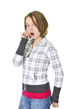 Teenage girl talking on a cell phone acting surprised isolated on white background