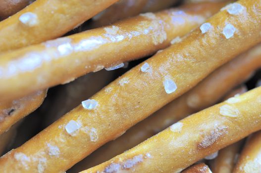 A macro view of salted pretzel sticks.