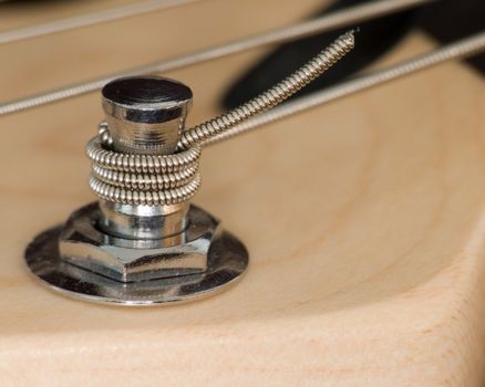 A macro shot of electric guitar machine heads used for tuning strings.