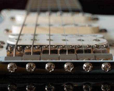 A macro view of a electric guitar bridge.