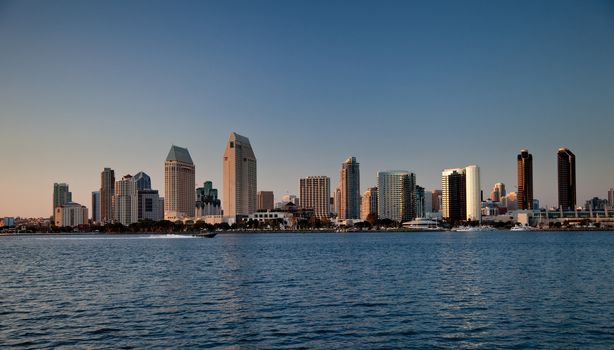 Sun setting lights up the buildings on San Diego seafront