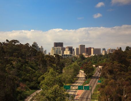 Unusual view of San Diego skyline off Cabrillo bridge from Balboa Park over empty interstate highway