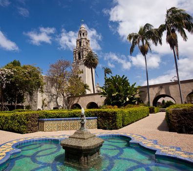 View of the ornate California Tower from the Alcazar Gardens with fountain in foreground in Balboa Park in San Diego