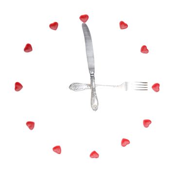 clock made from fruit jellies and dishware, show meal time, isolated on white