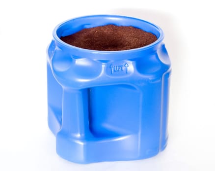 A blue container full of coffee grounds.