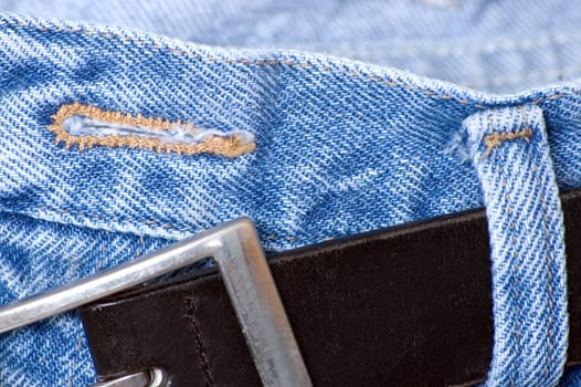 A button hole on a pair of denim jean pants.