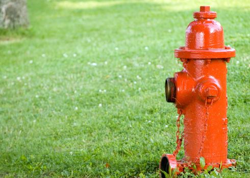 A red fire hydrant with a cap off.