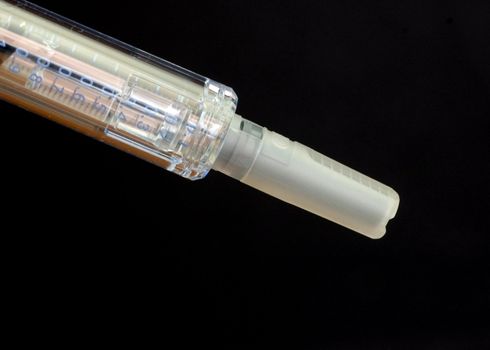 A close-up shot of a capped hypodermic needle.