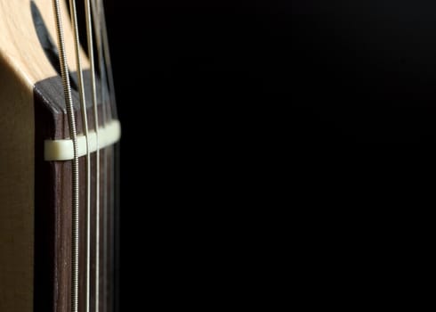 A section of an electric guitar with large copy space to the right.