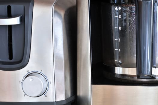 A coffee maker and toaster side by each.