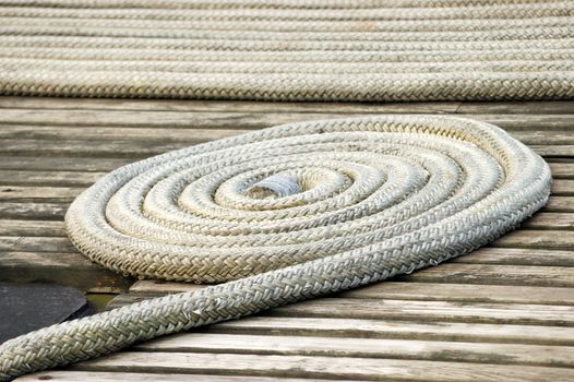 A coiled ship rope on the deck of a boat.