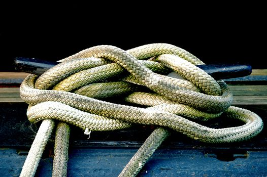 A coiled ship rope on the deck of a boat.